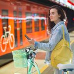 Teenager,Girl,With,Backpack,And,Bike,Standing,On,Metro,Station