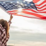 Young,Beautiful,Woman,Holding,Usa,Flag.