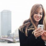 Young,Stylish,Pretty,Woman,Using,Smart,Phone,App,On,London