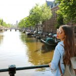 Portrait,Of,Traveler,Girl,With,Sunglasses,And,Backpack,Enjoying,Amsterdam