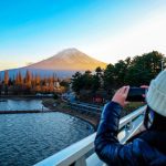 Young,Woman,Taking,Photo,With,Her,Phone,Of,The,View