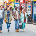 Group,Of,Young,Friends,Walking,In,Famous,Brick,Lane,In