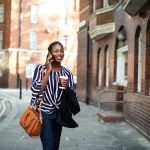 Woman,On,The,Phone,While,Walking,In,The,City
