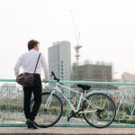 Back,View,Man,With,A,Bicycle,Stands,On,The,Bridge