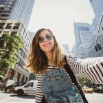 Pretty,Female,Girl,Tourist,Smiling,And,Taking,Selfie,In,Manhattan,