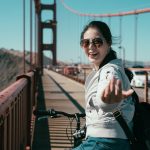 Girl,Backpacker,Riding,Bike,On,Pedestrian,On,Golden,Gate,Bridge.