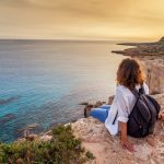 A,Stylish,Young,Woman,Traveler,Watches,A,Beautiful,Sunset,On