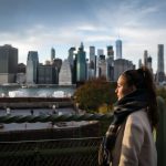 Young,Woman,Standing,On,Riverside,In,Brooklyn,And,Looking,On