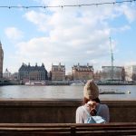 A,Girl,’s,Sitting,Beside,Thames,River,,Watching,London,City