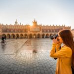 Young,Female,Tourist,With,Camera,And,Backpack,Photographing,Cloth,Hall