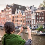 Beautiful,Young,Woman,Takes,Pictures,In,Vacation,Spent,In,Amsterdam