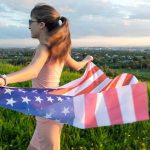 Back,View,Of,Happy,Young,Woman,Posing,With,Usa,National
