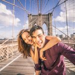 Beautiful,Couple,Taking,Selfie,On,Brooklyn,Bridge,,New,York,-