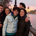 Portrait,Of,Friends,Walking,Along,South,Bank,On,Visit,To