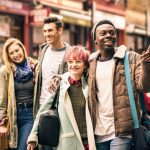 Happy,Multiracial,Friends,Walking,On,Brick,Lane,At,Shoreditch,London